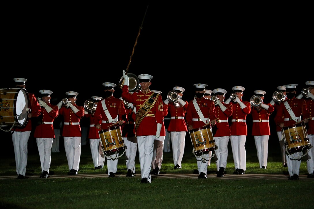 Gunnery Sgt. Joshua D. Dannemiller, assistant drum major, “The Commandant’s Own” U.S. Marine Drum and Bugle Corps, leads the D&B across the parade deck as a part of their “slow march” sequence during a Friday Evening Parade at Marine Barracks Washington, D.C., July 31, 2020. The Honorable Mr. James F. Geurts, Assistant Secretary of the Navy for Research, Development & Acquisition (ASN (RD&A)), was the guest of honor, and the Assistant Commandant of the Marine Corps, Gen. Gary L. Thomas, was the hosting official for the evening. To effectively host Evening Parades, the Barracks follows Department of Defense guidelines and Centers for Disease Control and Prevention (CDC) recommendations. Additionally, we apply several of Washington D.C.’s safeguards to include: physical distancing for patrons, health screenings, and mandatory wear of protective equipment.