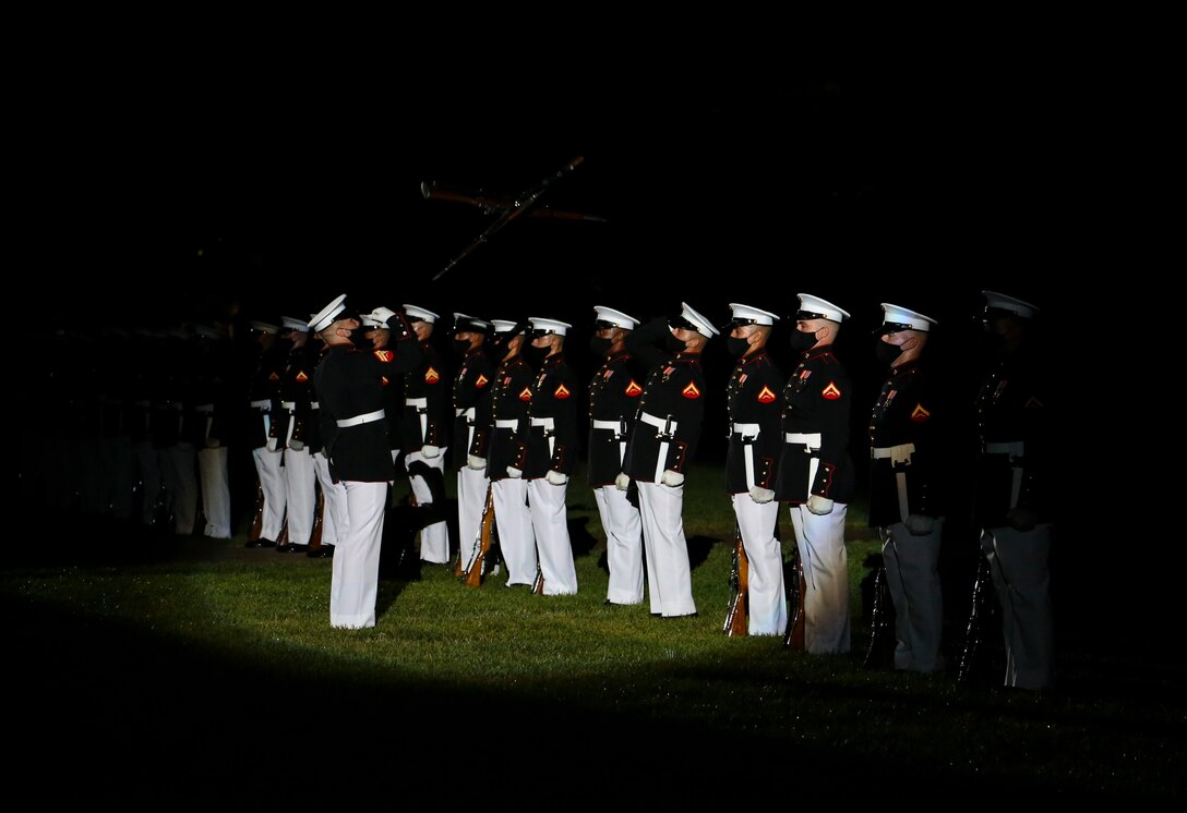 Corporal Alex Jorgensen, number one rifle inspector, U.S. Marine Corps Silent Drill Platoon, conducts rifle drill maneuvers with the doubles inspection team during a Friday Evening Parade at Marine Barracks Washington, D.C., July 31, 2020. The Honorable Mr. James F. Geurts, Assistant Secretary of the Navy for Research, Development & Acquisition (ASN (RD&A)), was the guest of honor, and the Assistant Commandant of the Marine Corps, Gen. Gary L. Thomas, was the hosting official for the evening. To effectively host Evening Parades, the Barracks follows Department of Defense guidelines and Centers for Disease Control and Prevention (CDC) recommendations. Additionally, we apply several of Washington D.C.’s safeguards to include: physical distancing for patrons, health screenings, and mandatory wear of protective equipment.