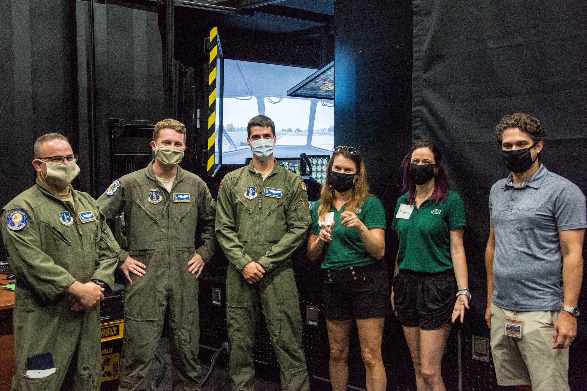 U.S. Air Force Master Sgt. Steve Verdinelli, Staff Sgt. William Turner and U.S. Air Force First Lt. Jason Waters in front of the C-130 flight simulator with Dover Public Library staff members (left to right) Heather Bernat, Susan Elizabeth Cordle and Nicholas Coll, July 29, 2020 at New Castle Air National Guard base, Del. Members of the library staff visited the wing to live-stream an episode of their Tour a Truck educational series.