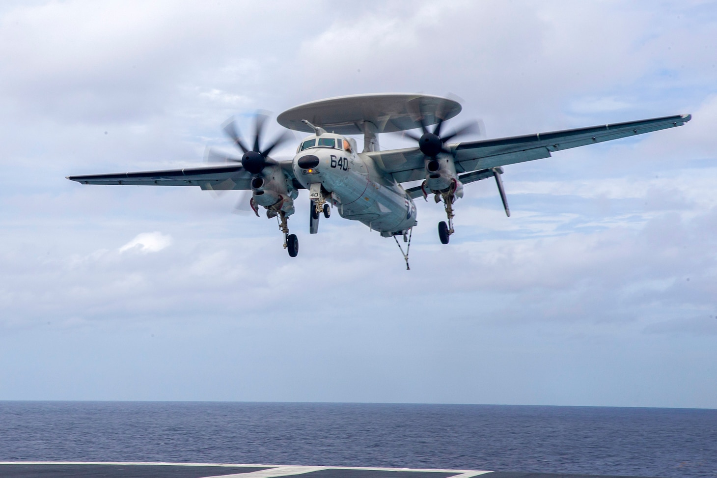 An E-2D Tracer, attached to the "Greyhawks" of Airborne Command and Control Squadron (VAW) 120, approaches the  flight deck of the aircraft carrier USS Gerald R. Ford (CVN 78).