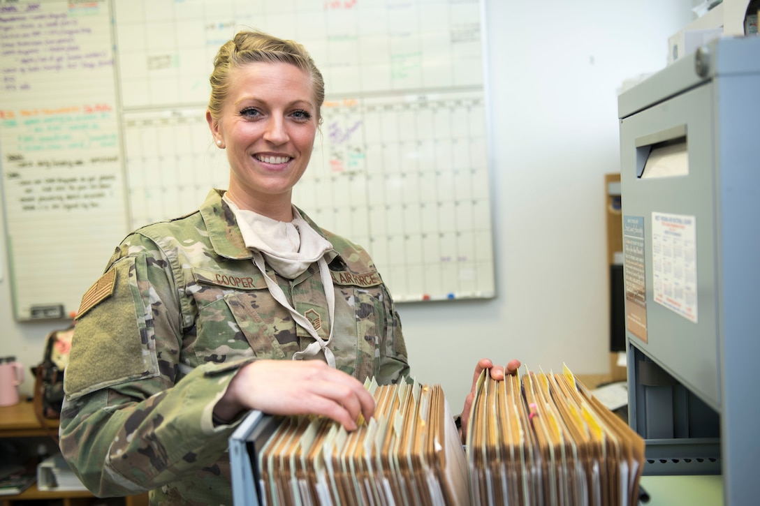 Master Sgt. Jennifer Cooper, NCOIC Public Health, 167th Medical Group, searches for a file in her office, at the 167th Airlift Wing, Martinsburg, W. Va., June 11, 2020. Disease prevention is the core function of her office.