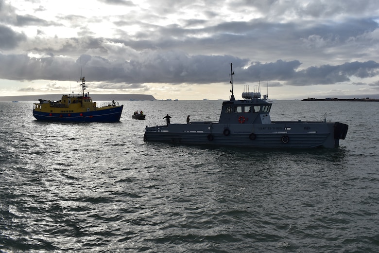 Air Force tugboat, “Rising Star,” tows a rescued commercial ship into the harbor at Thule Air Base, Greenland, Monday, Aug. 3. “The rapid efforts and teamwork of the 821st Air Base Group, Vectrus Services, the Royal Danish Air Force, Joint Arctic Command and the Joint Rescue Coordination Center were instrumental in saving lives today,” said Col. David Hanson, Thule AB installation commander. (U.S. Air Force photo by Lt. Col. Christopher Iavarone)