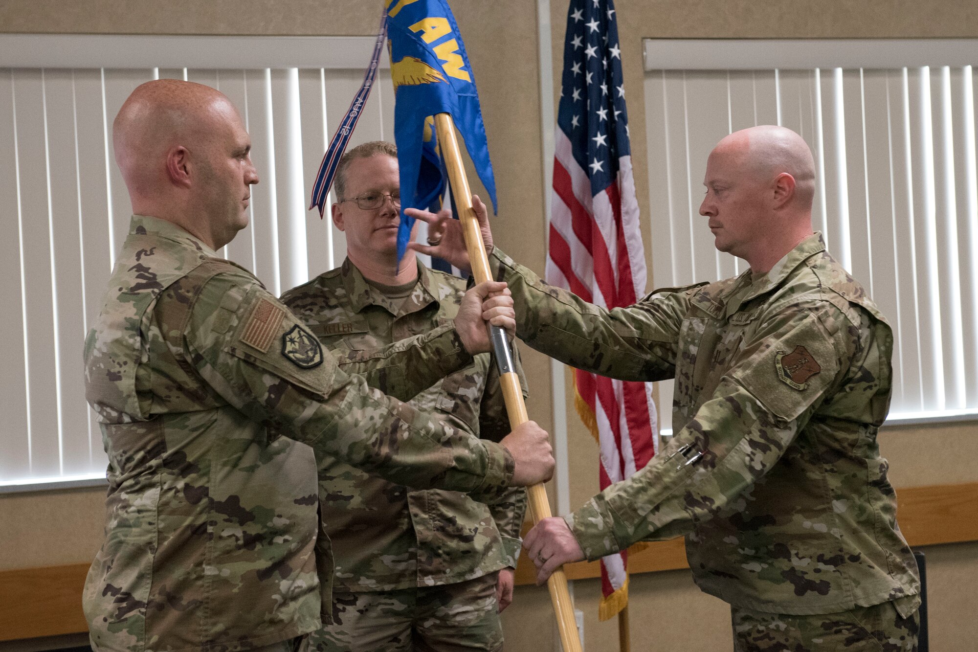 Capt. Rod Toms, right, accepts the 167th Security Forces Squadron guidon, from Col. Bill Annie, 167th Mission Support Group commander, during a change of command ceremony at the 167th Airlift Wing, Aug. 1, 2020. Lt. Col. Tim Rice relinquished command of the squadron to Toms during the ceremony.