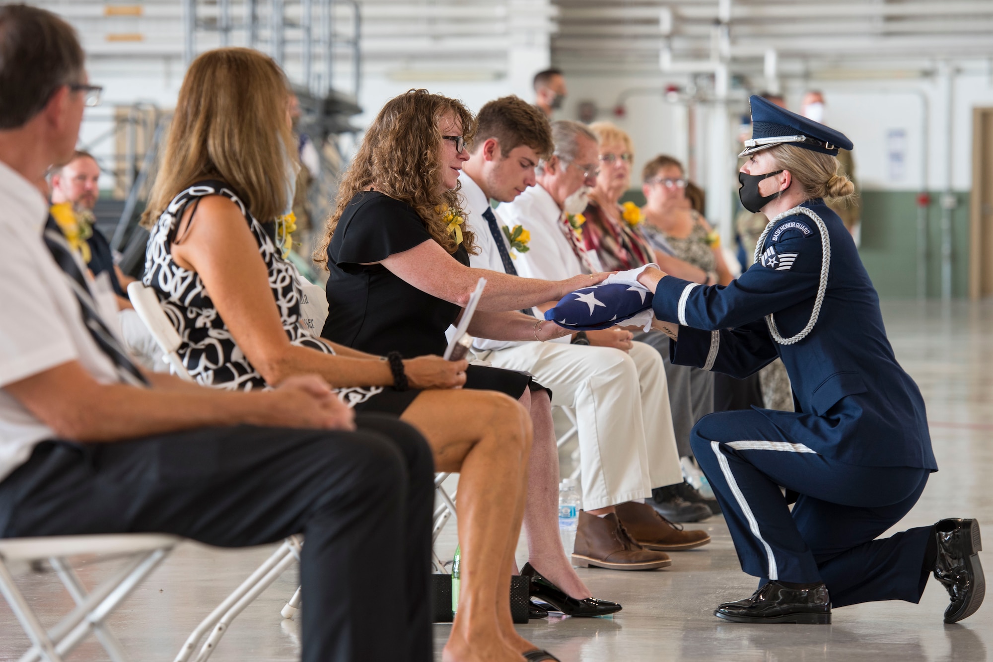 Staff Sgt. Kayla Hoffmaster, 167th Airlift Wing honor guard member, presents an American flag to Mrs. Donna Nasser during the memorial service for Lt. Col. Chris Nasser held at the 167th Airlift Wing, Aug. 2. Nasser wife Donna, and son Colin, were presented with Lt. Col. Nasser’s Meritorious Service Medal, West Virginia Legion of Merit and a shadowbox representing his 30 year military career.