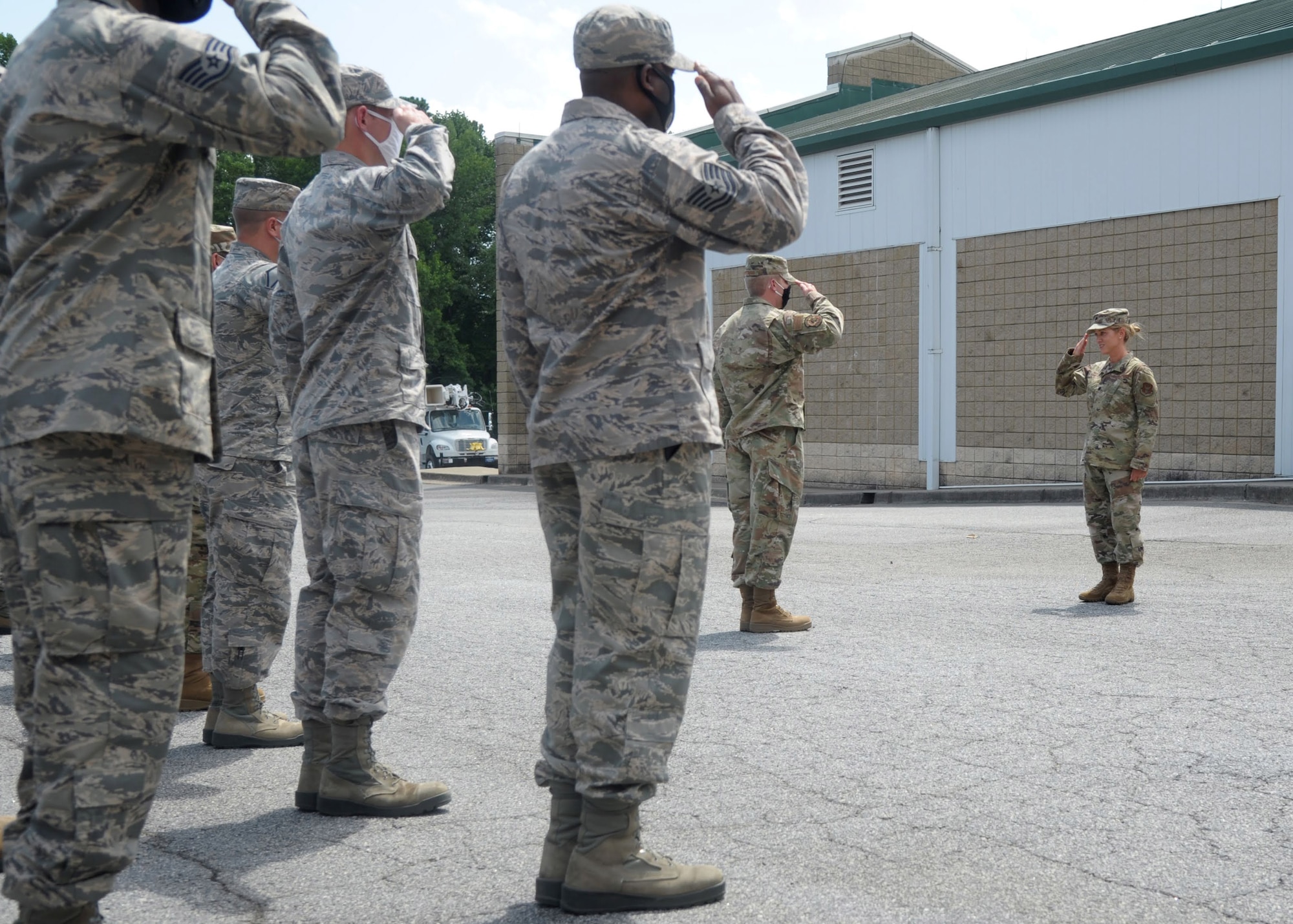 Airmen from the 94th Civil Engineer Squadron render a welcoming salute to Lt. Col. Emily Steinfort, incoming commander of the 94th CES, Aug. 1, 2020, at the 94th CES building. Steinfort plans to surpass the expectations of Headquarters so that her Airmen are ready for anything. (U.S. Air Force photo by Senior Airman Shelby Thurman)