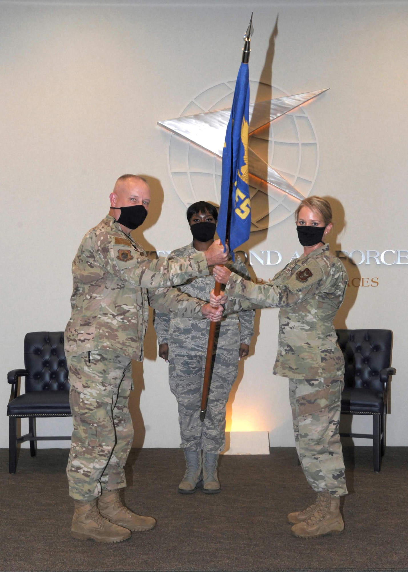 Colonel Joseph Revit, 94th Mission Support Group commander, passes the guidon to Lt. Col. Emily Steinfort, incoming commander of the 94th Civil Engineer Squadron, Aug. 1, 2020, at the 22nd Air Force Headquarters. Steinfort plans to surpass the expectations of Headquarters so that her Airmen are ready for anything. (U.S. Air Force photo by Senior Airman Shelby Thurman)