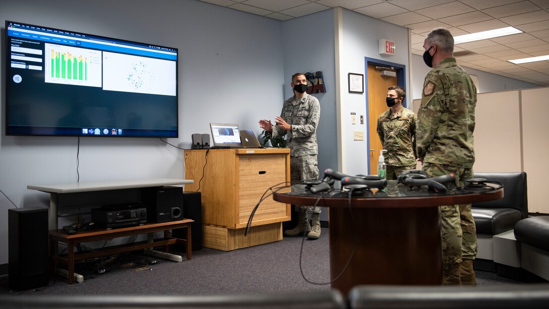 Capt. Brandon Hufstetler, 533rd Training Squadron instructor, shows Maj. Gen. Stephan Whiting, United States Space Force deputy commander, a new program he developed to track personnel in the unit during Covid-19 to ensure mission readiness at the 533rd TRS, Vandenberg Air Force Base, Calif., July 29, 2020. During the visit, Whiting visited various units and learned about new developments for the 30th Space Wing, Combined Force Space Component Command, and 381st Training Group at Vandenberg AFB. (U.S. Air Force photo by Senior Airman Aubree Owens)