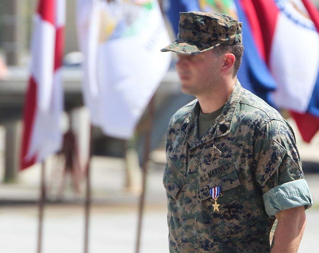 A Marine Raider was awarded the Silver Star Medal for heroic actions while deployed to Afghanistan in 2019, at a ceremony aboard Marine Corps Base Camp Lejeune. July 10, 2020. The master sergeant and Critical Skills Operator, was serving as a Team Chief with 2nd Marine Raider Battalion in support of Operation Freedom’s Sentinel when his team was engaged by enemy combatants. According to the award citation, during a heliborne raid into difficult enemy-controlled terrain in Southern Afghanistan, he led his team of Marine Raiders and partner nation forces in four hours of close combat with more than a dozen Taliban fighters occupying defensive strongholds.  The Team Chief exposed himself to enemy fire to lead an assault across 30 meters of open terrain, attacking Taliban fighters entrenched in a bunker with his rifle and hand grenades. While he and his team took accurate enemy fire, the Team Chief again exposed himself by climbing on top a building to employ a roof charge in order to recover a wounded Afghan soldier. With enemy fighters barricaded just a few feet away, he heroically pulled the wounded man to a covered position in a valiant attempt to save his life, while allowing his team to engage the barricaded fighters with fragmentation grenades.