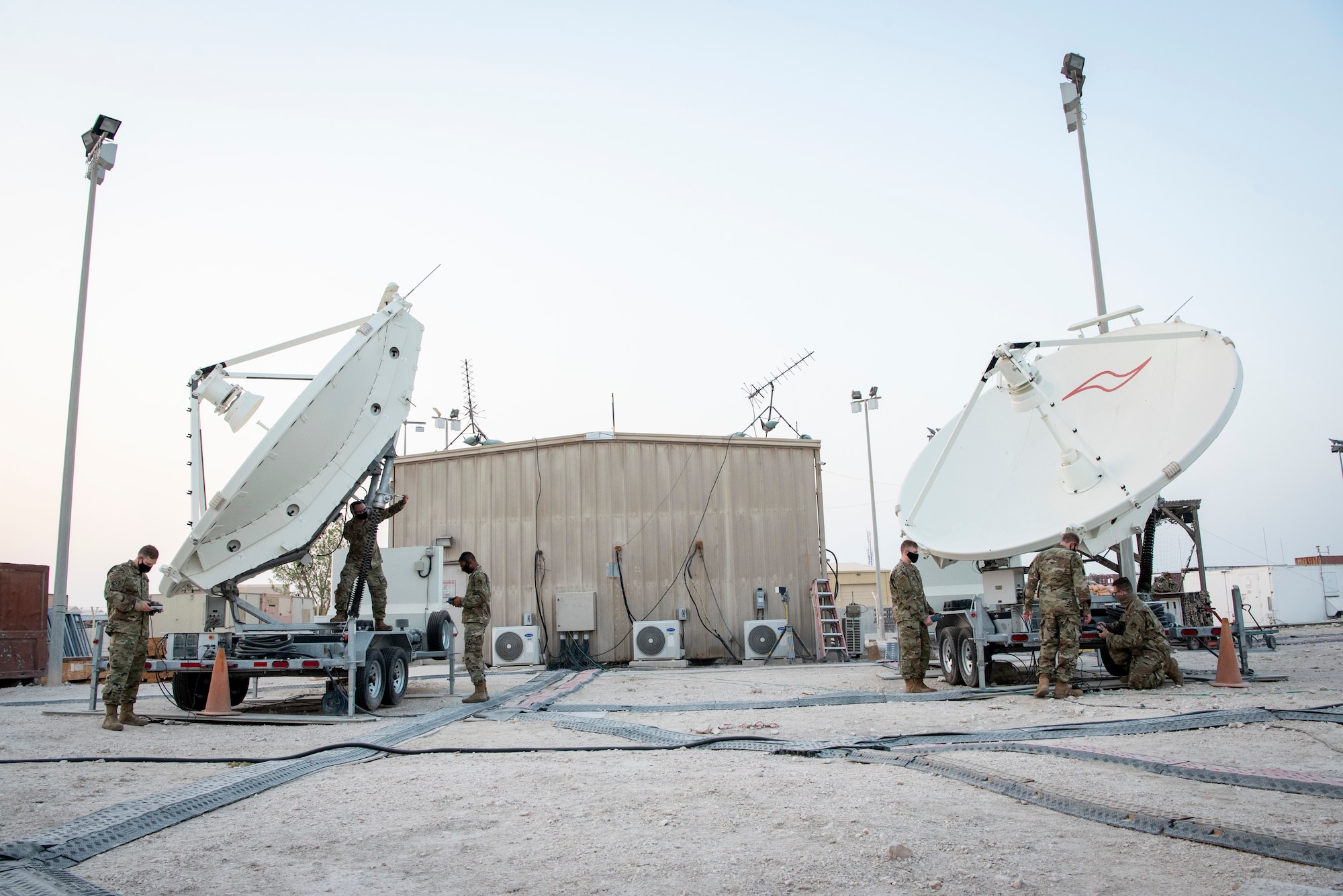 U.S. Air Force Airmen from the 16th Space Control Squadron, perform routine maintenance operations on satellite dishes at Al Udeid Air Base, Qatar, July 30, 2020. Operation Silent Sentry protects critical satellite communication links by employing multiple weapons systems for space electronic warfare. (U.S. Air Force photo by Tech. Sgt. Michael Battles)