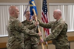 Capt. Rod Toms, right, accepts the 167th Security Forces Squadron guidon, from Col. Bill Annie, 167th Mission Support Group commander, during a change of command ceremony at the 167th Airlift Wing, Aug. 1, 2020. Lt. Col. Tim Rice relinquished command of the squadron to Toms during the ceremony.