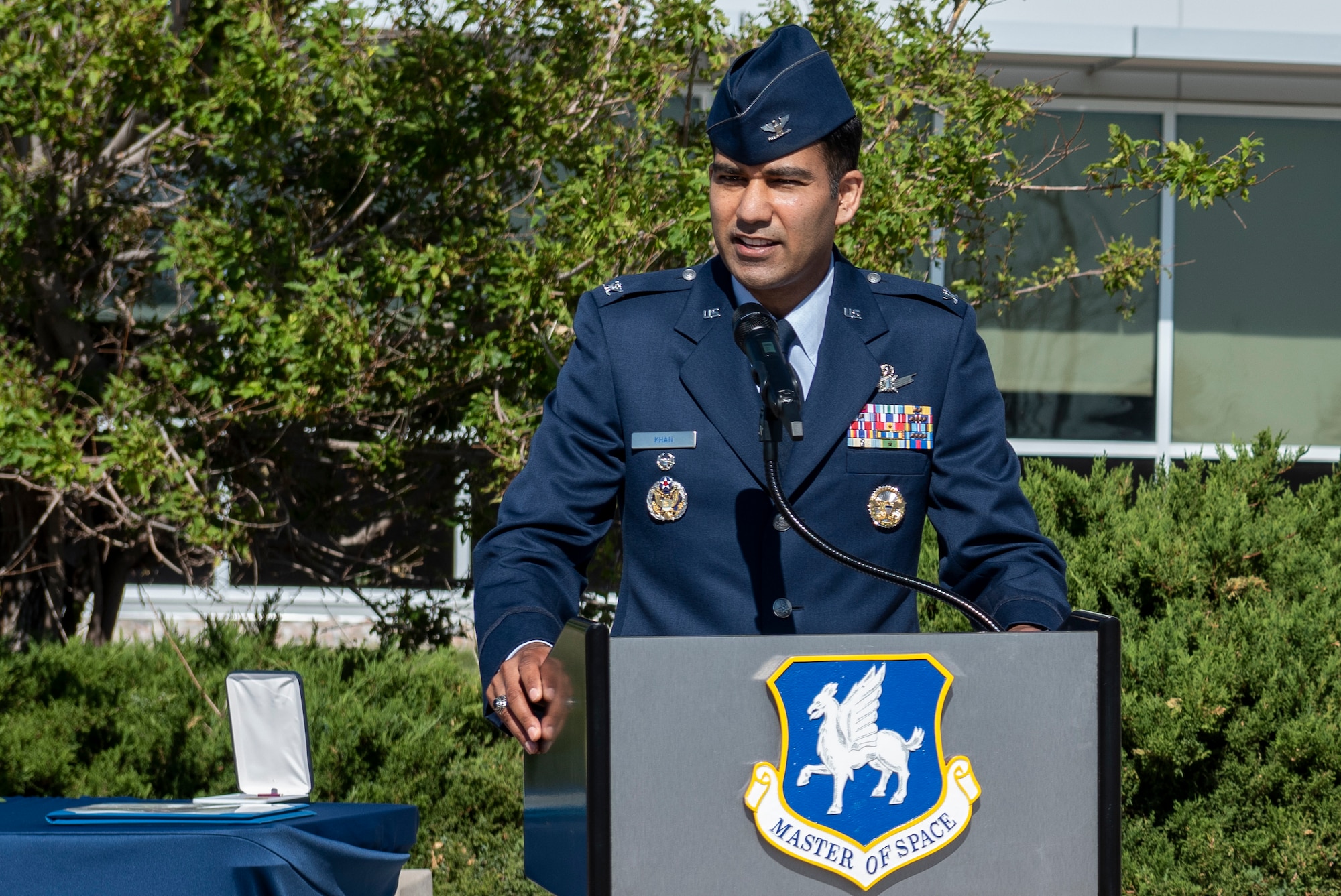 Photo of a man standing behind a podium outside.