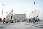 U.S. Air Force Airmen from the 16th Space Control Squadron, perform routine maintenance operations on satellite dishes at Al Udeid Air Base, Qatar, July 30, 2020. Operation Silent Sentry protects critical satellite communication links by employing multiple weapons systems for space electronic warfare. (U.S. Air Force photo by Tech. Sgt. Michael Battles)