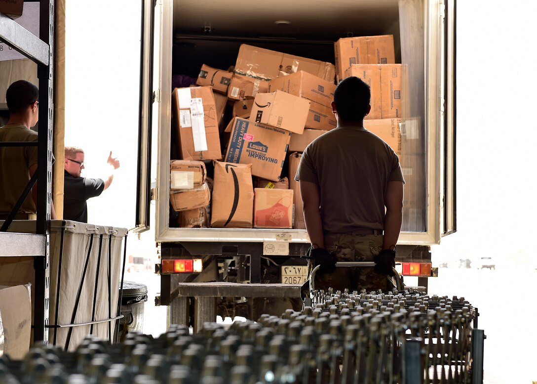 Airmen from the 378th Expeditionary Force Support Squadron receive packages at Prince Sultan Air Base, Kingdom of Saudi Arabia.