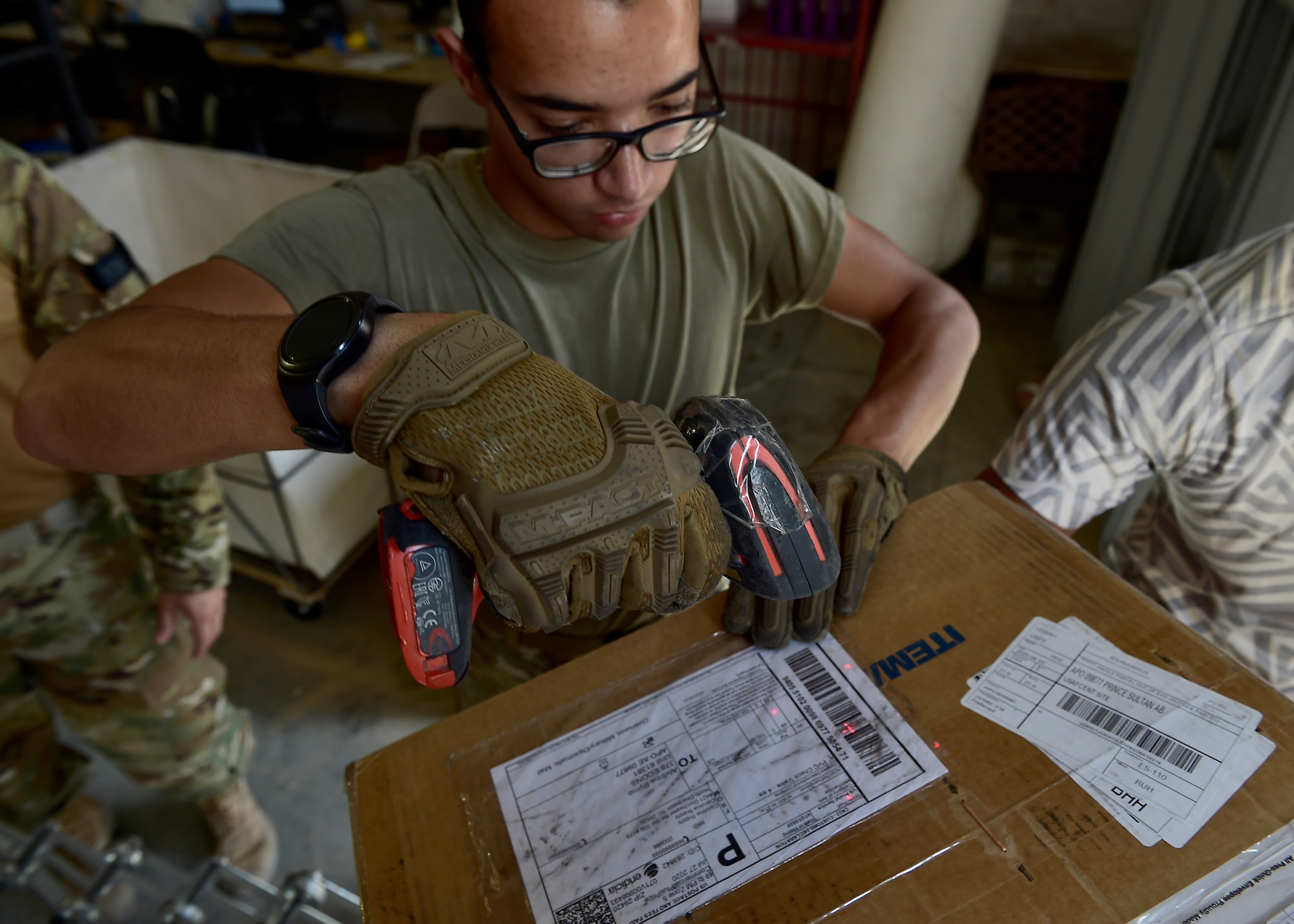 Airmen from the 378th Expeditionary Force Support Squadron receive packages at Prince Sultan Air Base, Kingdom of Saudi Arabia.