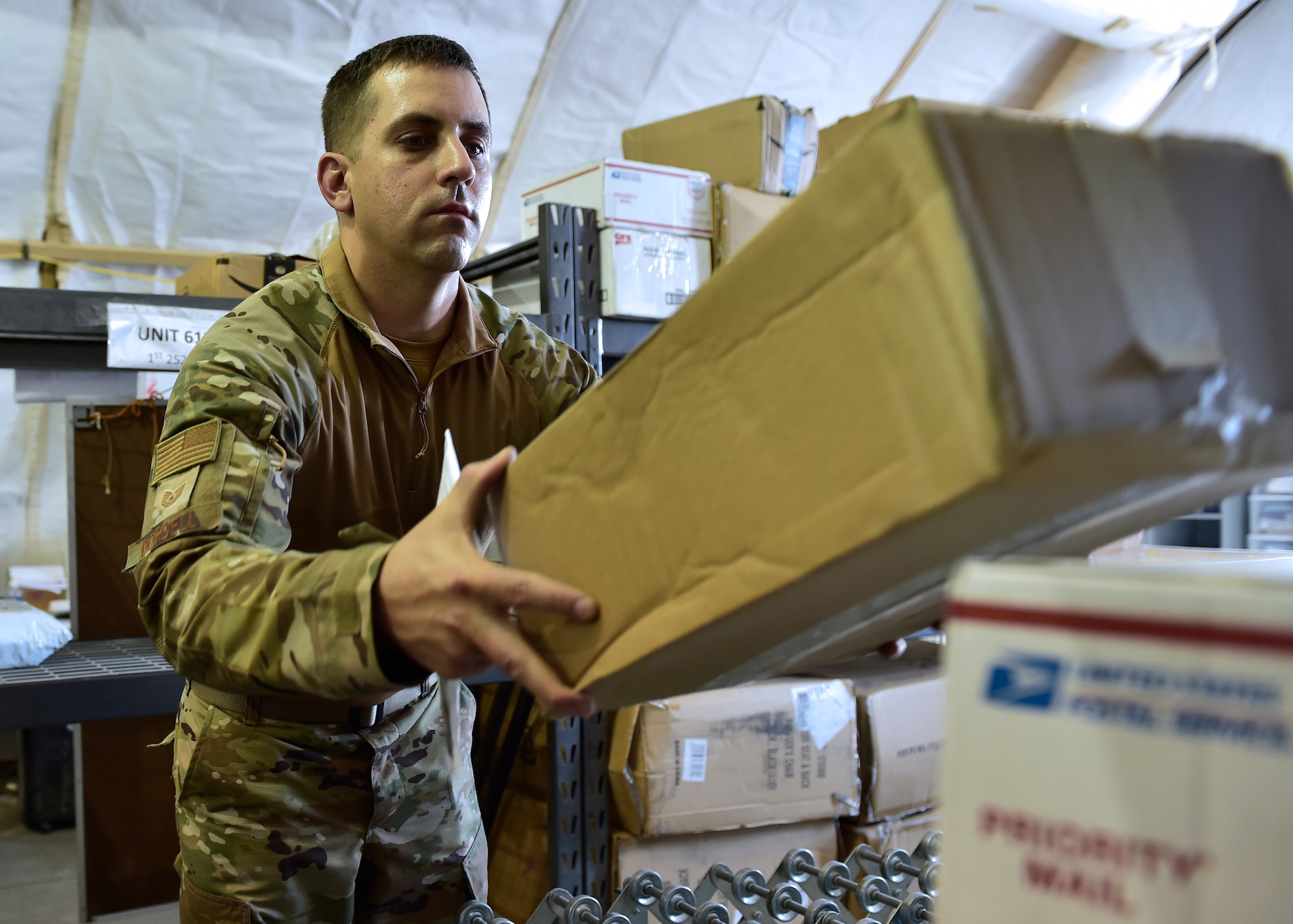 Airmen from the 378th Expeditionary Force Support Squadron receive packages at Prince Sultan Air Base, Kingdom of Saudi Arabia.