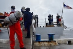 Coast Guard Cutter Legare crew members offload about 3,900 pounds of marijuana.