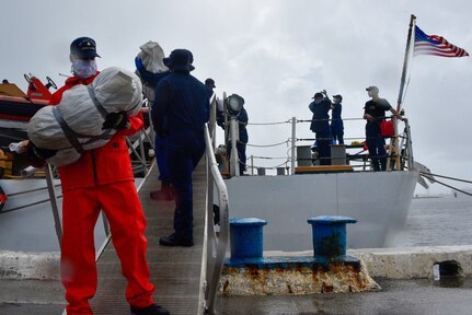 Coast Guard Cutter Legare crew members offload about 3,900 pounds of marijuana.
