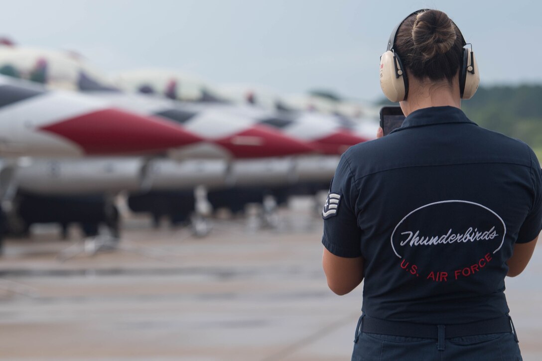 A U.S. Air Force Thunderbird team member takes video during the arrival of the aircraft at Joint Base Langley-Eustis, Virginia, Aug. 5, 2020.