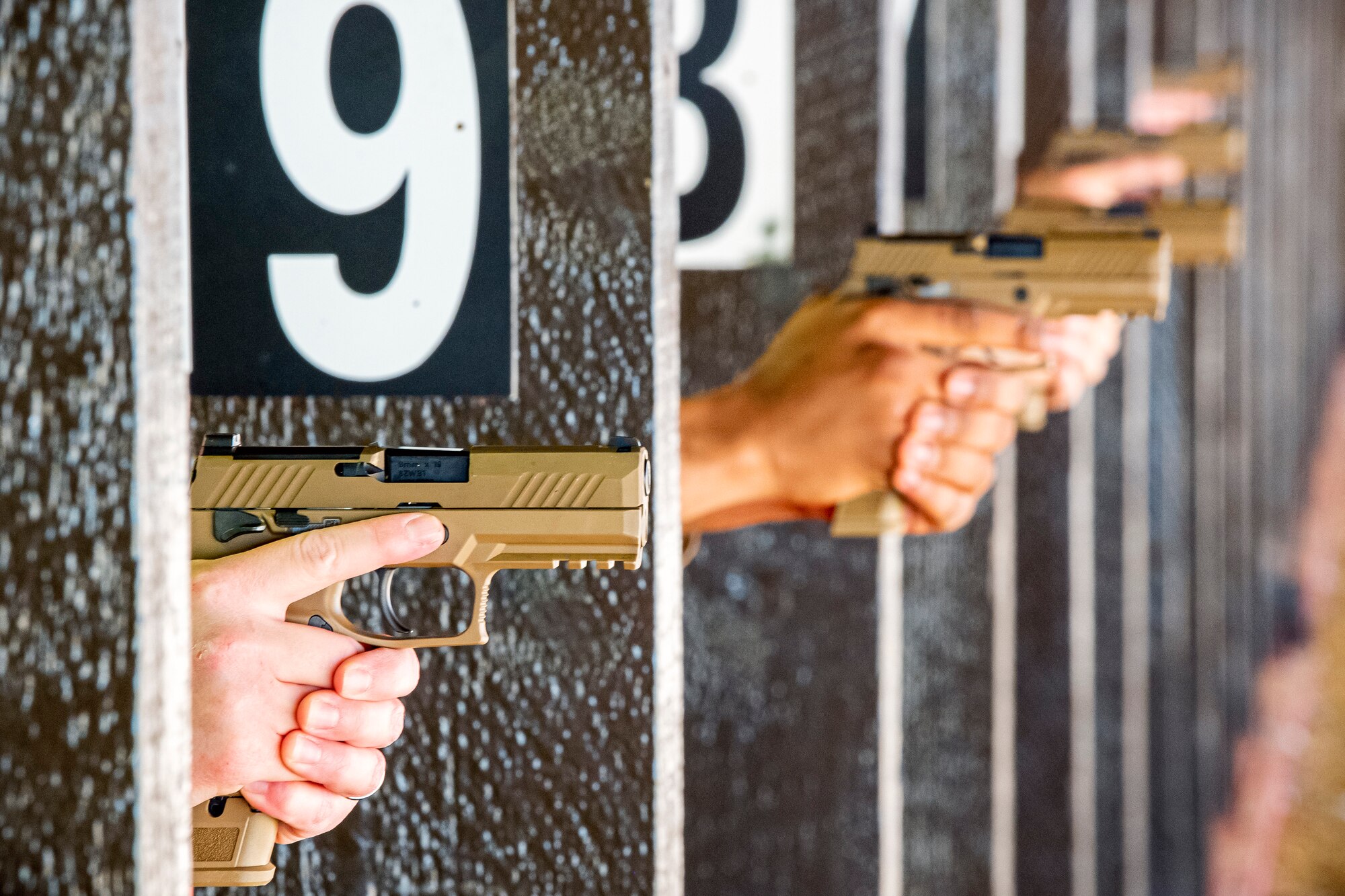 U.S. Air Force Airmen from the 423rd Security Forces Squadron (SFS) fire an M18 handgun, during a qualification course at RAF Molesworth, England, July 28, 2020. The M18 Sig Sauer Modular Handgun System will be replacing the M9 Beretta which has been in use for over 30 years. During the course, Airmen from the 423rd SFS became familiar with the M18 and learned about its various functions and its overall benefits such as improved ergonomics, target acquisition, reliability and durability to increase shooter lethality. (U.S. Air Force photo by Senior Airman Eugene Oliver)