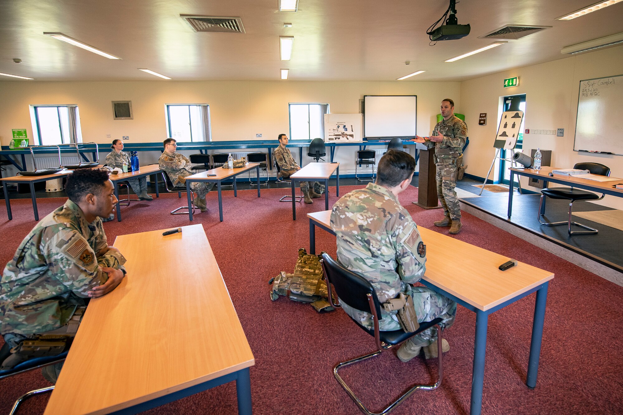 U.S. Air Force Staff Sgt. Kevin Campbell, right, 423rd Security Forces Squadron (SFS), noncommissioned officer in charge of combat arms training and maintenance, instructs Airmen from the 423rd SFS during a M18 handgun qualification course at RAF Molesworth, England, July 28, 2020. During the course, Airmen from the 423rd SFS became familiar with the M18 and learned about its various functions and overall benefits such as improved ergonomics, target acquisition, reliability and durability to increase shooter lethality. The M18 Sig Sauer Modular Handgun System will be replacing the M9 Beretta which has been in use for over 30 years. (U.S. Air Force photo by Senior Airman Eugene Oliver)