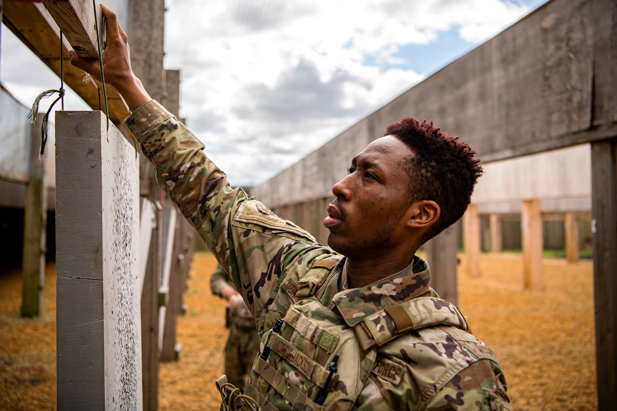 U.S. Air Force Airman 1st Class Shawn Morris-Jackson, 423rd Security Forces Squadron (SFS) armory patrolman, sets up his target sheet during a M18 handgun qualification course at RAF Molesworth, England, July 28, 2020. During the course, Airmen from the 423rd SFS became familiar with the M18 and learned about its various functions and its overall benefits such as improved ergonomics, target acquisition, reliability and durability to increase shooter lethality. The M18 Sig Sauer Modular Handgun System will be replacing the M9 Beretta which has been in use for over 30 years. (U.S. Air Force photo by Senior Airman Eugene Oliver)