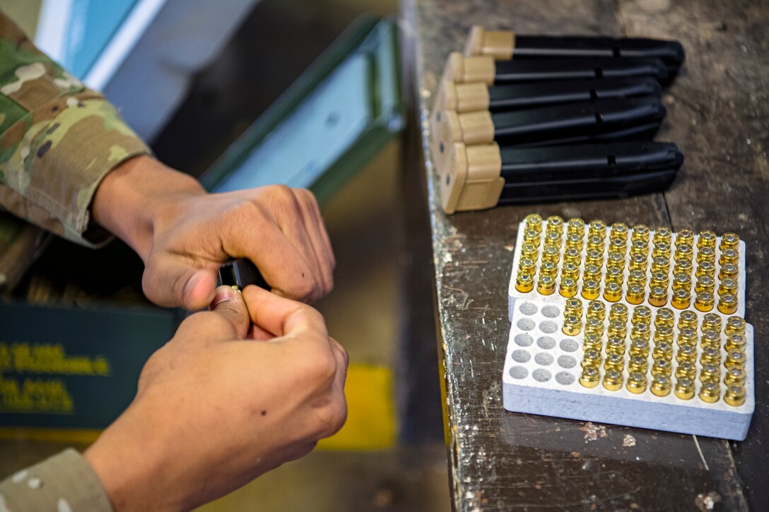 An U.S. Air Force Airman from the 423rd Security Forces Squadron (SFS), prepares to load simulated rounds into the magazine of an M18 handgun during a M18 qualification course at RAF Molesworth, England, July 28, 2020. The M18 Sig Sauer Modular Handgun System will be replacing the M9 Beretta which has been in use for over 30 years. During the course, Airmen from the 423rd SFS became familiar with the M18 and learned about its various functions and overall benefits such as improved ergonomics, target acquisition, reliability and durability to increase shooter lethality. (U.S. Air Force photo by Senior Airman Eugene Oliver)