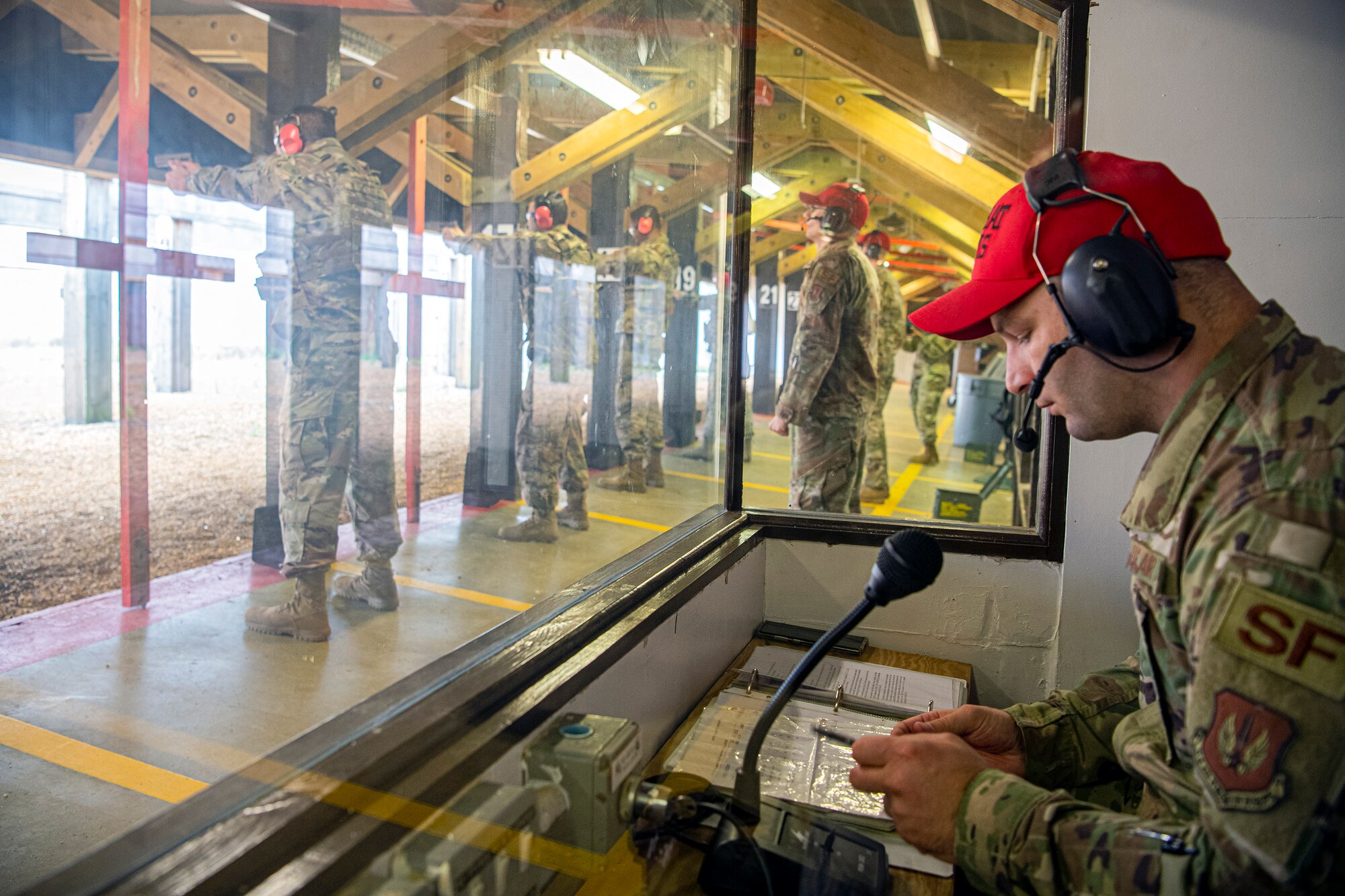 U.S. Air Force Staff Sgt. Kevin Campbell, right, 423rd Security Forces Squadron (SFS), noncommissioned officer in charge of combat arms training and maintenance (CATM), gives instruction during a M18 handgun qualification course at RAF Molesworth, England, July 28, 2020. During the course, CATM instructors taught Airmen from the 423rd SFS about the M18 and instructed about its various functions and overall benefits such as improved ergonomics, target acquisition, reliability and durability to increase shooter lethality. The M18 Sig Sauer Modular Handgun System will be replacing the M9 Beretta which has been in use for over 30 years. (U.S. Air Force photo by Senior Airman Eugene Oliver)