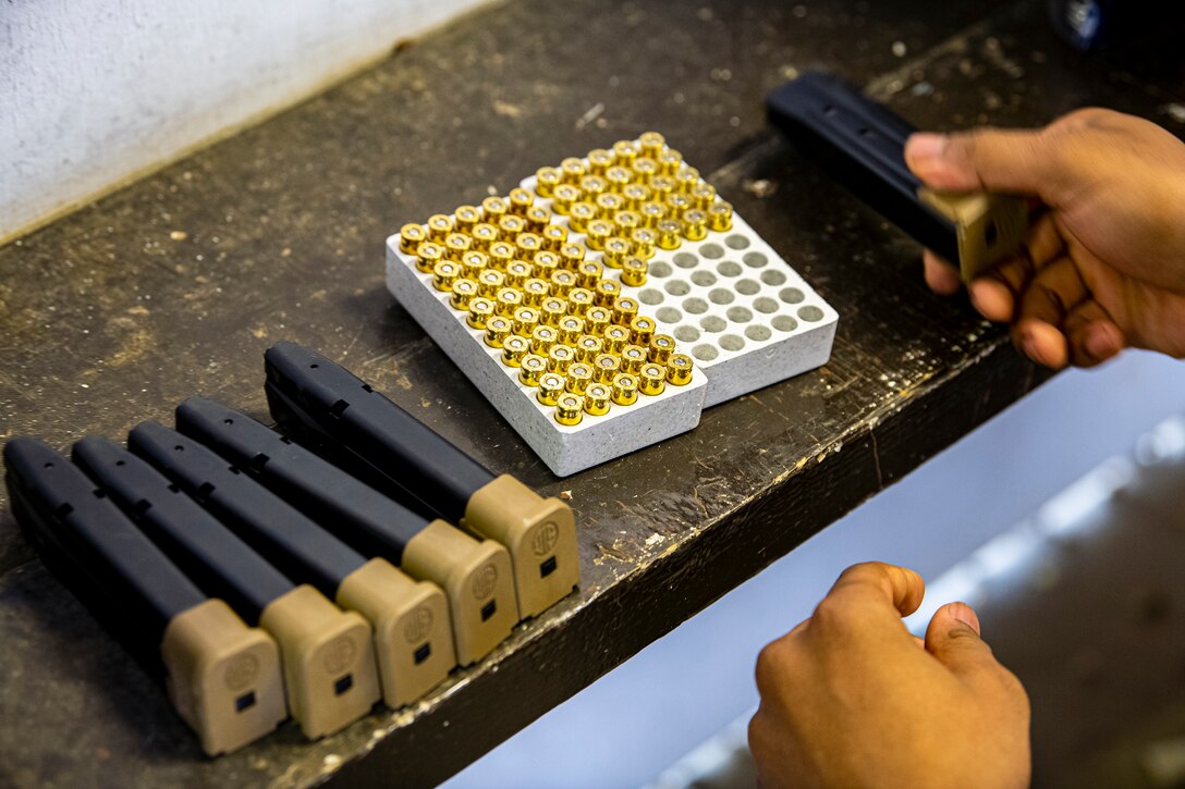 An U.S. Air Force Airman from the 423rd Security Forces Squadron (SFS), prepares to load simulated rounds into the magazine of an M18 handgun during a M18 qualification course at RAF Molesworth, England, July 28, 2020. The M18 Sig Sauer Modular Handgun System will be replacing the M9 Beretta which has been in use for over 30 years. During the course, Airmen from the 423rd SFS became familiar with the M18 and learned about its various functions and overall benefits such as improved ergonomics, target acquisition, reliability and durability to increase shooter lethality. (U.S. Air Force photo by Senior Airman Eugene Oliver)