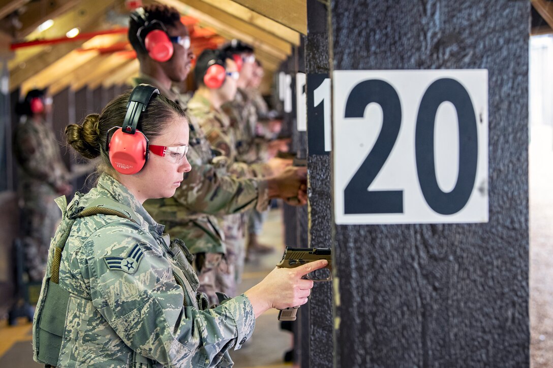 U.S. Air Force Airmen from the 423rd Security Forces Squadron (SFS) prepare to fire the M18 handgun during a qualification course at RAF Molesworth, England, July 28, 2020. The M18 Sig Sauer Modular Handgun System will be replacing the M9 Beretta which has been in use for over 30 years. During the course, Airmen from the 423rd SFS became familiar with the M18 and learned about its various functions and its overall benefits such as improved ergonomics, target acquisition, reliability and durability to increase shooter lethality.  (U.S. Air Force photo by Senior Airman Eugene Oliver)