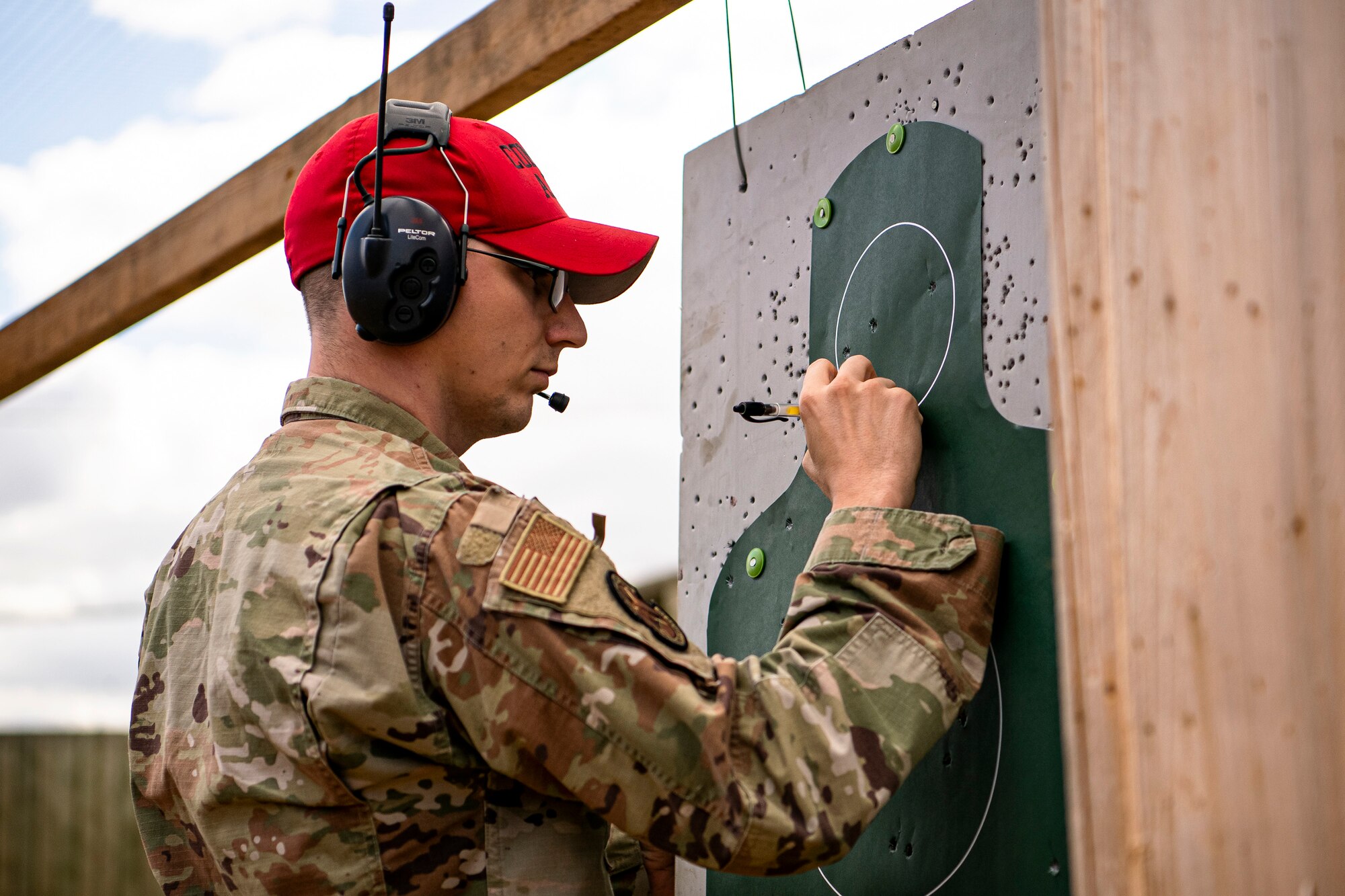 U.S. Air Force Staff Sgt. David Ward, 423rd Security Forces Squadron (SFS) combat arms training and maintenance (CATM) instructor, scores a target during a M18 handgun qualification course at RAF Molesworth, England, July 28, 2020. During the course, CATM instructors taught Airmen from the 423rd SFS about the M18 and instructed about its various functions. The M18 Sig Sauer Modular Handgun System will be replacing the M9 Beretta which has been in use for over 30 years. (U.S. Air Force photo by Senior Airman Eugene Oliver)