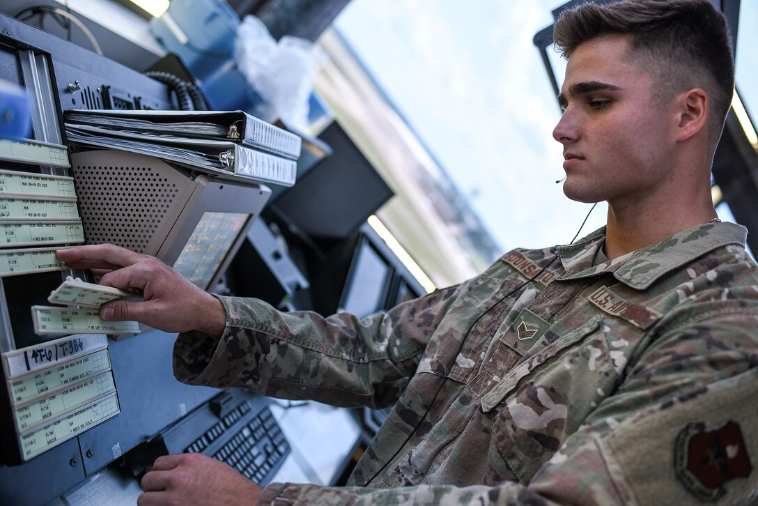 Senior Airman Nico Buonsanto, 14th Operations Support Squadron Air Traffic Controller, moves flight strips while in the new Tower Coordinator position August 4, 2020, on Columbus Air Force Base, Miss. Columbus AFB Air Traffic Control Tower leadership developed and implemented the new Tower Coordinator (CT) position, effective June 1, 2020, splitting the duties and responsibilities of the overtasked Flight Data (FD) position. (U.S. Air Force photo by Senior Airman Keith Holcomb)