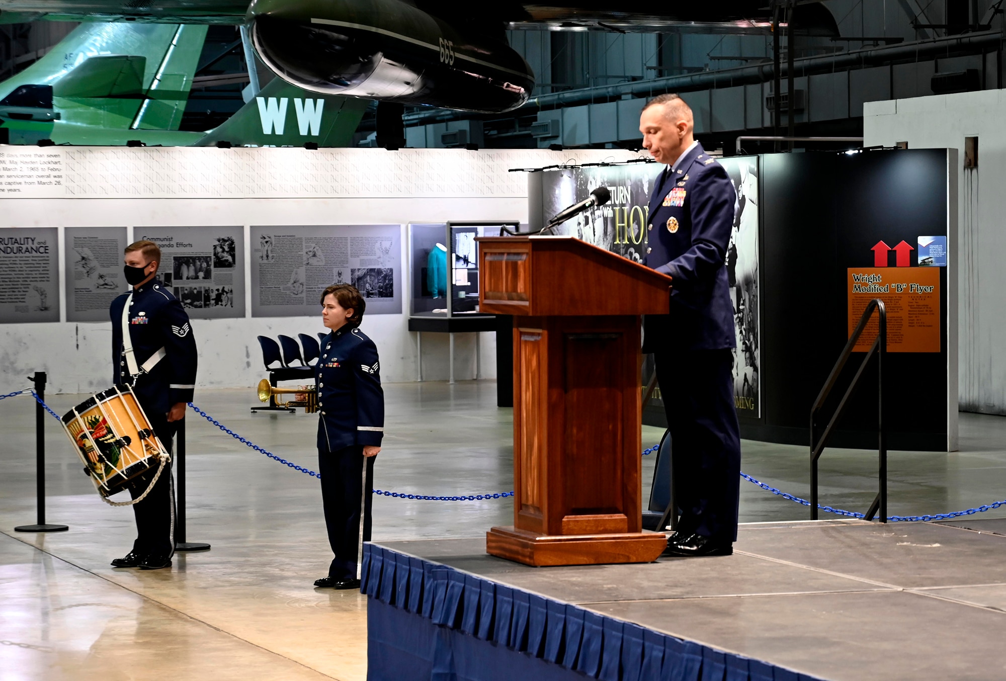 Col. Lyle Drew, Air Force Materiel Command Director of Staff, addresses the audience at the start of the promotion ceremony for Col. Jeannine Ryder, Air Force Materiel Command Surgeon General, to the rank of brigadier general at the National Museum of the United States Air Force, Wright-Patterson Air Force Base, Ohio, Aug. 3. Ryder is now one of only a small number of general officers in the U.S. Air Force Medical Service. (photo by Darrius Parker)