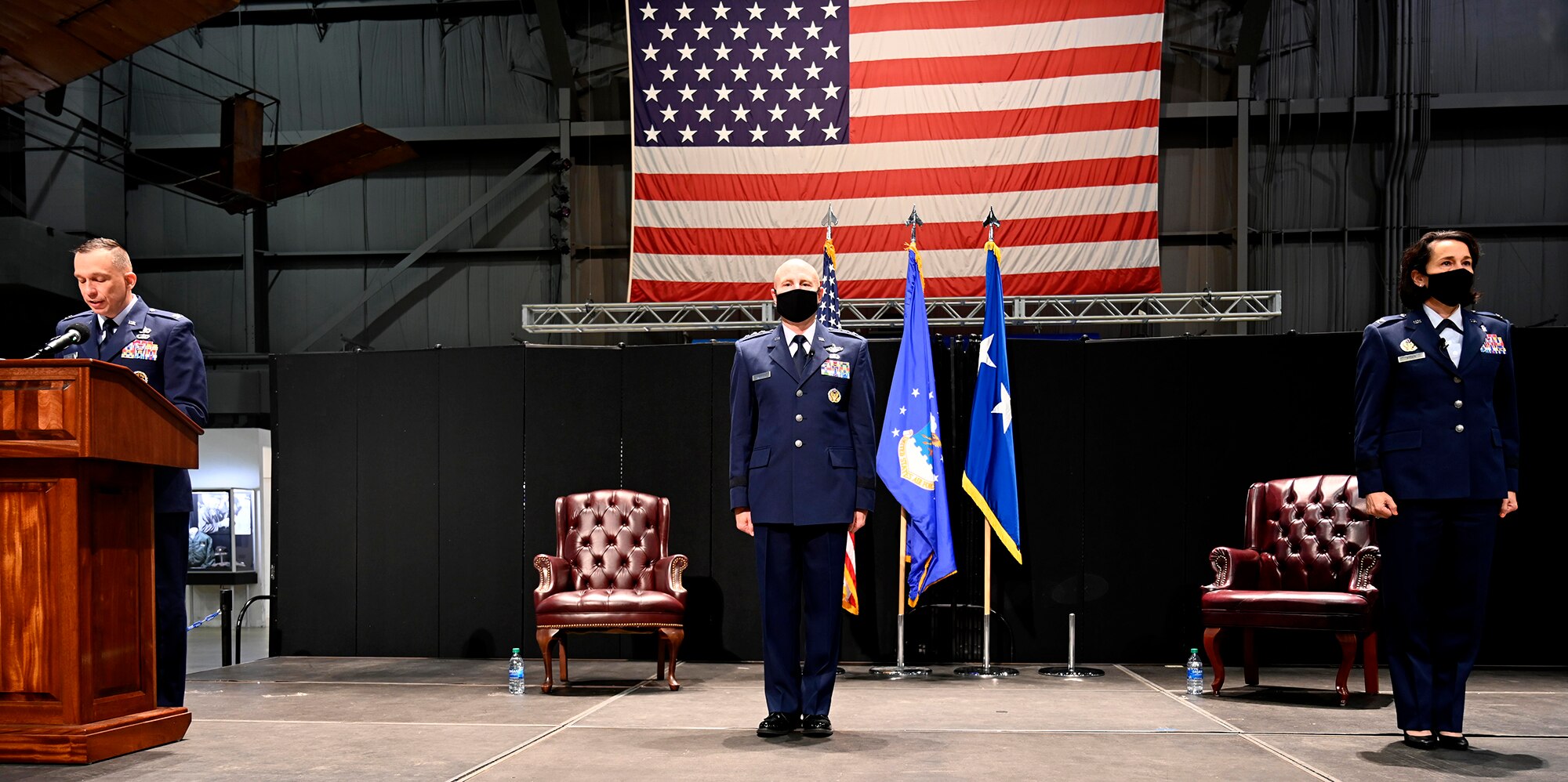 Col. Lyle Drew announces the general officer promotion as Lt. Gen Carl Schaefer and Col. Jeannine Ryder stand at attention Aug. 3 at the National Museum of the United States Air Force, Wright-Patterson Air Force Base, Ohio. (photo by Darrius Parker)