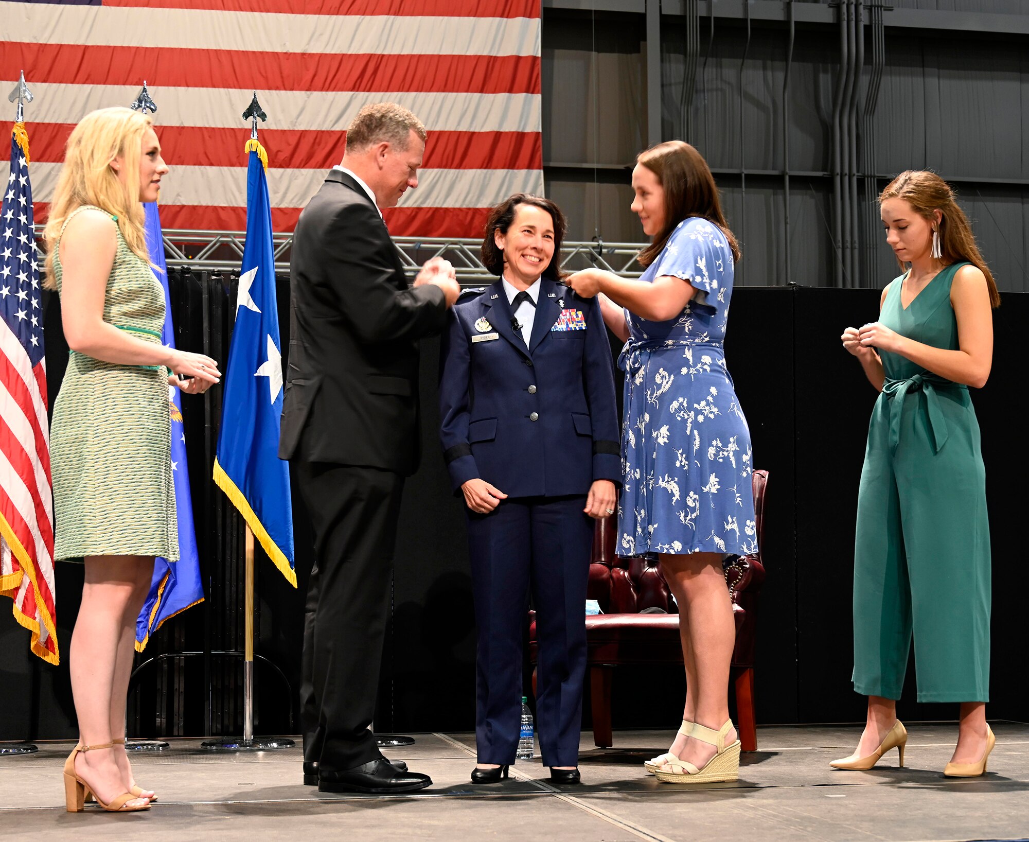 Col. Jeannine Ryder smiles as her family pins the rank of brigadier general on her uniform Aug. 3 at the National Museum of the United States Air Force, Wright-Patterson Air Force Base, Ohio. (photo by Darrius Parker)
