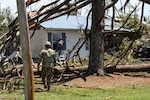 North Carolina National Guard Spc. Adam Macterrnan, a Soldier assigned to the 882nd Engineer Company, 105th Engineer Battalion, helps a resident find his dogs following a tornado spawned by Hurricane Isaias in Windsor, North Carolina, Aug. 4, 2020.