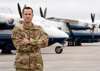 Photo of Airman standing in front of an aircraft