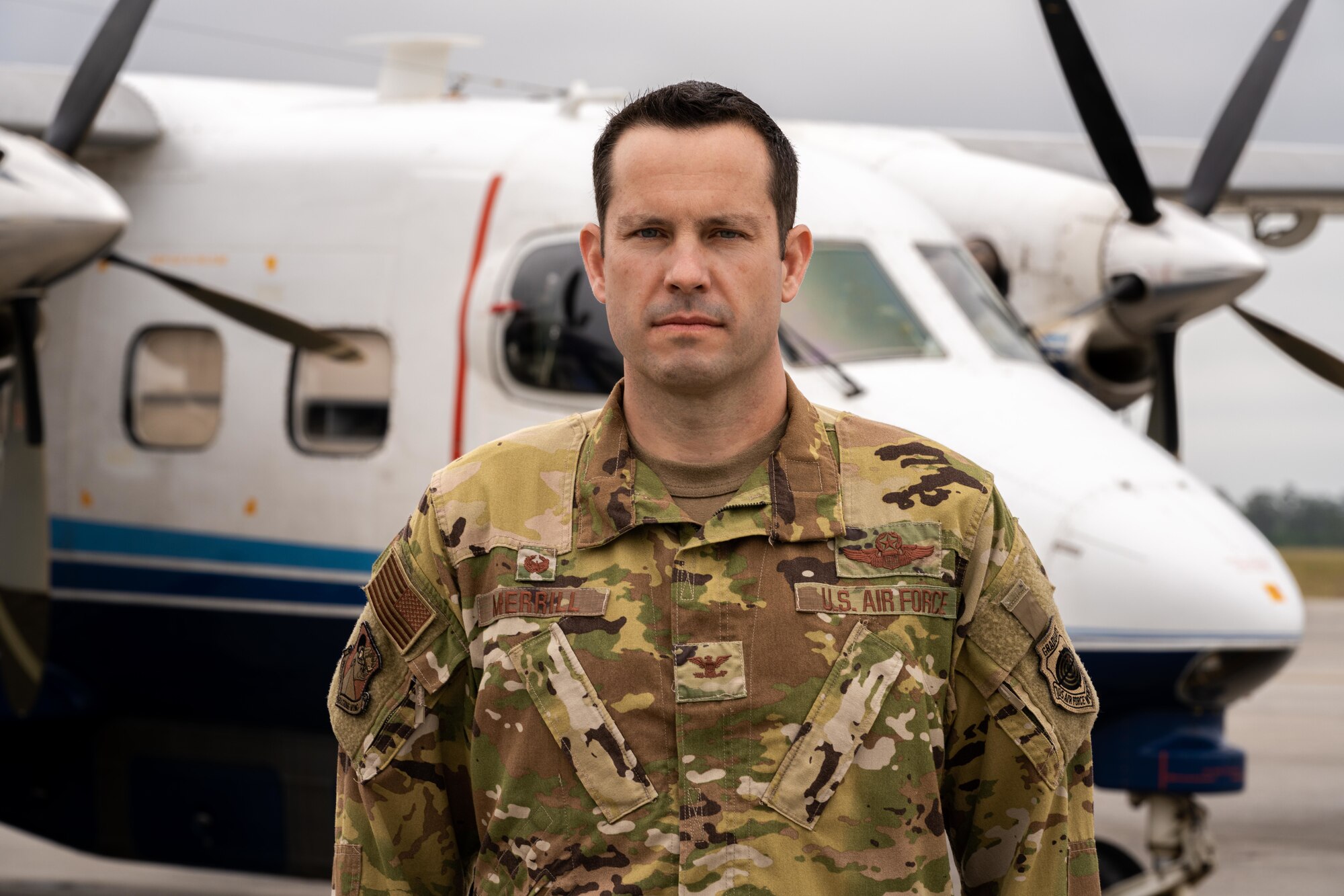 Photo of Airman standing in front of aircraft