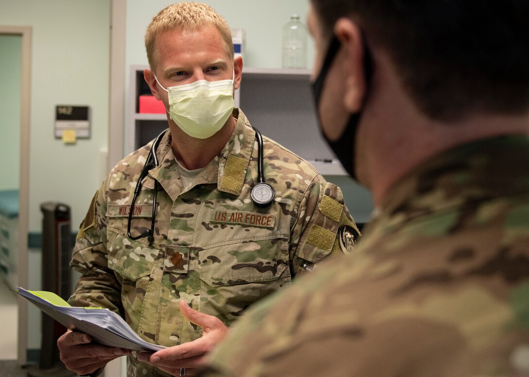 Flight Surgeon speaks to coworker.