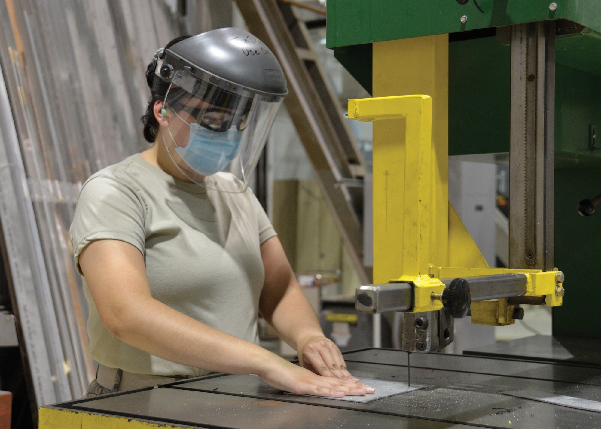 Senior Airman Jordan Kletschka, an aircraft structural maintenance apprentice with the 445th Maintenance Squadron fabrication flight, uses a band saw to cut metal at Wright-Patterson Air Force Base, Ohio, July 12, 2020. (U.S. Air Force photo/Staff Sgt. Ethan Spickler)