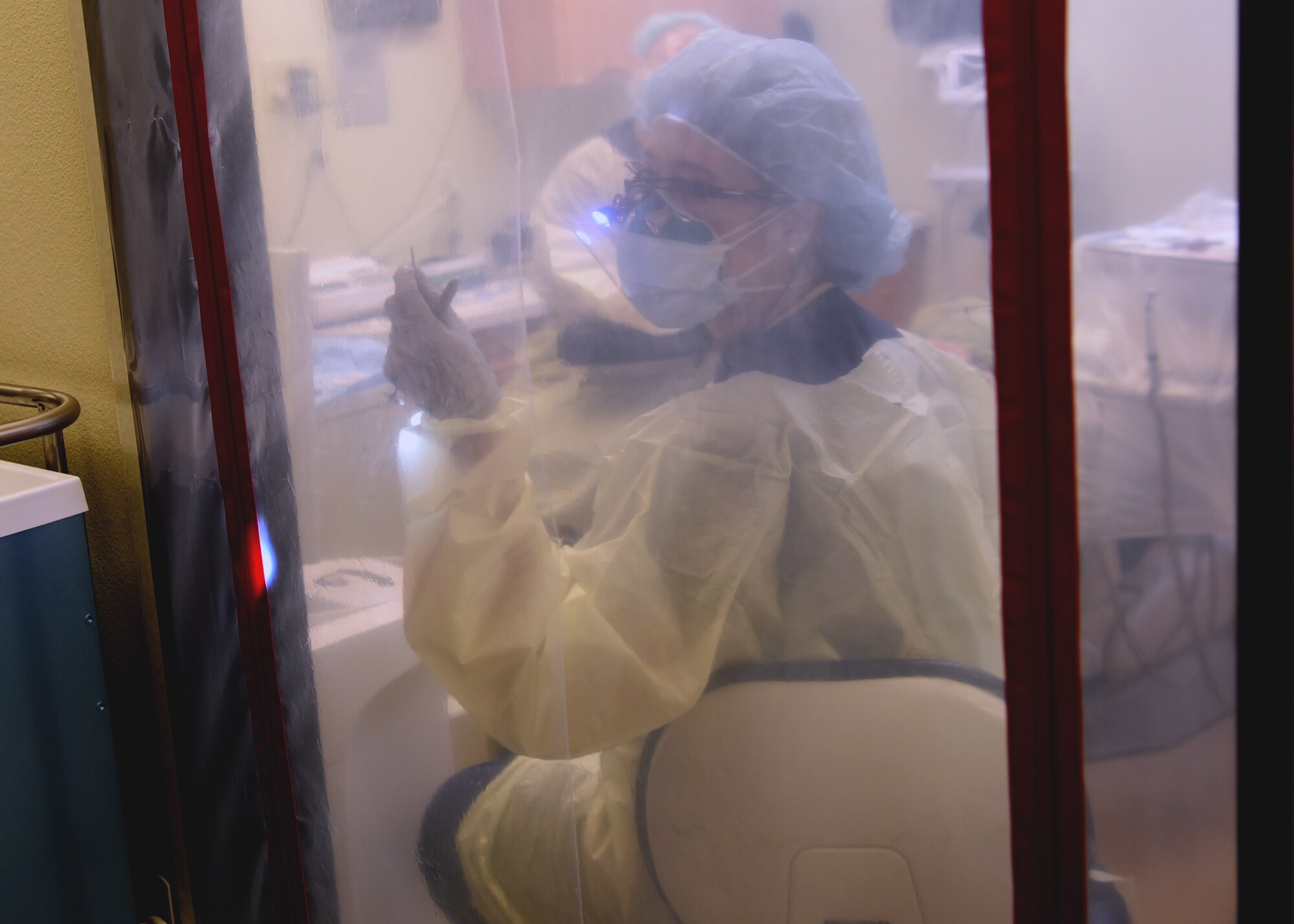 U.S. Air Force Capt. Melissa Seibert, 17th Medical Group general dentist, wears personal protective equipment to avoid undetected COVID-19 exposure, while performing dental duties, at the Ross Clinic’s dental facility, on Goodfellow Air Force Base, Texas, Aug. 5, 2020. In addition to Seibert’s PPE, the Ross Clinic enforced a single-point entry control, COVID-19 questionnaire screenings and protective reception desk and patient exam room barriers to remain undeterred through the pandemic.  (U.S. Air Force photo by Airman 1st Class Abbey Rieves)