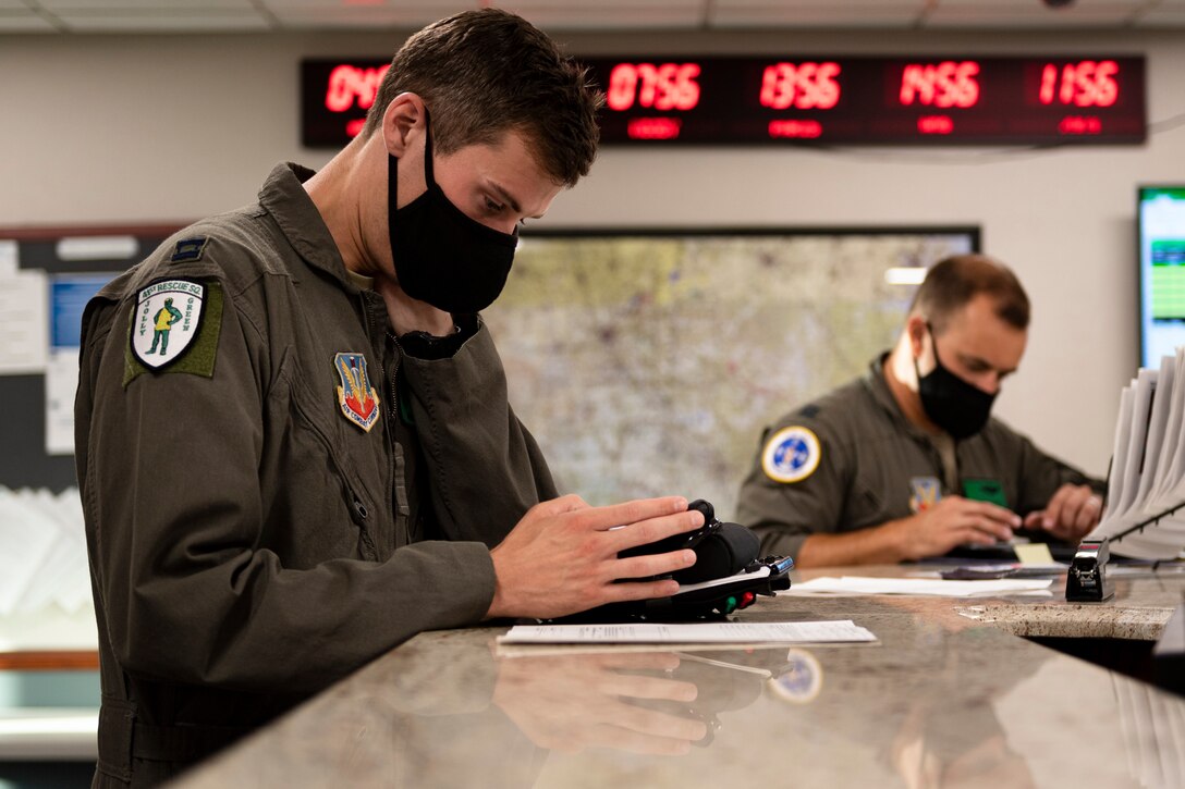 A photo of an Airman looking over flight information