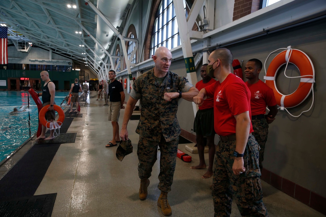 The 19th Sergeant Major of the Marine Corps, Sgt. Maj. Troy E. Black greets Drill Instructors with 1st Recruit Training Battalion at Marine Corps Recruit Depot (MCRD) Parris Island, South Carolina, July 22, 2020. During the visit Sgt. Maj. Black toured the training facilities to observe changes made keep recruits and Drill Instructors safe during COVID-19 restrictions. The changes include the use of face masks when less than six feet apart, and smaller platoon sizes in addition to the 14 days of restriction of movement before new recruits start training. (U.S. Marine Corps photo by Sgt. Victoria Ross)