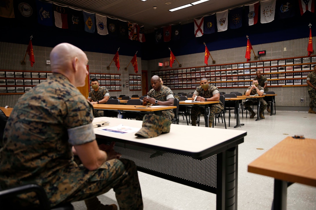 The 19th Sergeant Major of the Marine Corps, Sgt. Maj. Troy E. Black sits in a command brief at the Drill Instructor School at Marine Corps Recruit Depot (MCRD) Parris Island, South Carolina, July 22, 2020. During the visit Sgt. Maj. Black toured the training facilities to observe changes made keep recruits and Drill Instructors safe during COVID-19 restrictions. The changes include the use of face masks when less than six feet apart, and smaller platoon sizes in addition to the 14 days of restriction of movement before new recruits start training. (U.S. Marine Corps photo by Sgt. Victoria Ross)