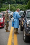 Members of the West Virginia National Guard assigned to Task Force Medical and Task Force CRE assist local officials in Logan County, West Virginia to conduct public testing for COVID-19, August 02, 2020. Eight members of the WVNG augmented the Logan County Health Department and Logan County Emergency Ambulance Authority with drive-up testing for more than 200 residents of Logan County, West Virginia after a recent increase in local cases of the pandemic virus. (U.S. Army National Guard photo by Edwin L. Wriston)