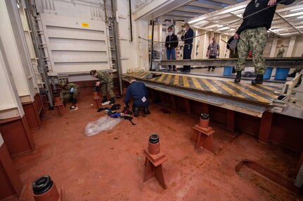 U.S. Sailors perform preservation on a lower stage weapons elevator aboard the aircraft carrier USS John C. Stennis (CVN 74) in Norfolk, Virginia, May 11, 2020.