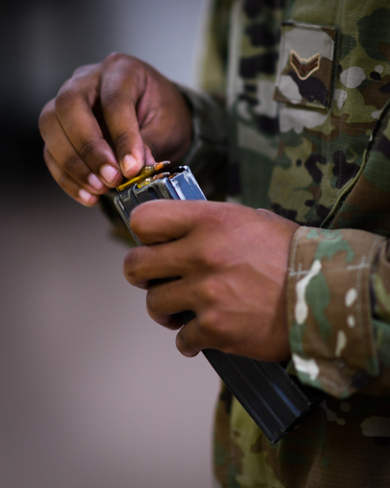 A Reserve Citizen Airman, a medical specialist with the 910th Medical Squadron, loads 5.56x45mm NATO cartridges into an M4 carbine magazine at the Combat Arms Training and Maintenance firing range, August 1, 2020, Youngstown Air Reserve Station, Ohio. Medical professionals are required to qualify in combat arms every 36 months to remain mission ready.