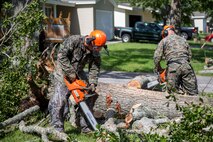 U.S. Marine Corps Lance Cpl. Antonio C. Villanueva, left, and Lance Cpl. Daniel Startt, right, both combat engineers with 8th Engineer Support Battalion, 2nd Marine Logistics Group, clear debris with a chainsaw at Berkeley Manor on Marine Corps Base Camp Lejeune, North Carolina, Aug. 4, 2020. U.S. Marines carried out recovery efforts after Hurricane Isaias in order to resume normal operations while following COVID-19 mitigation guidelines. (U.S. Marine Corps Photo by Lance Cpl. Isaiah Gomez)