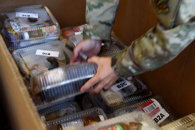 Photo of Airman sorting meals