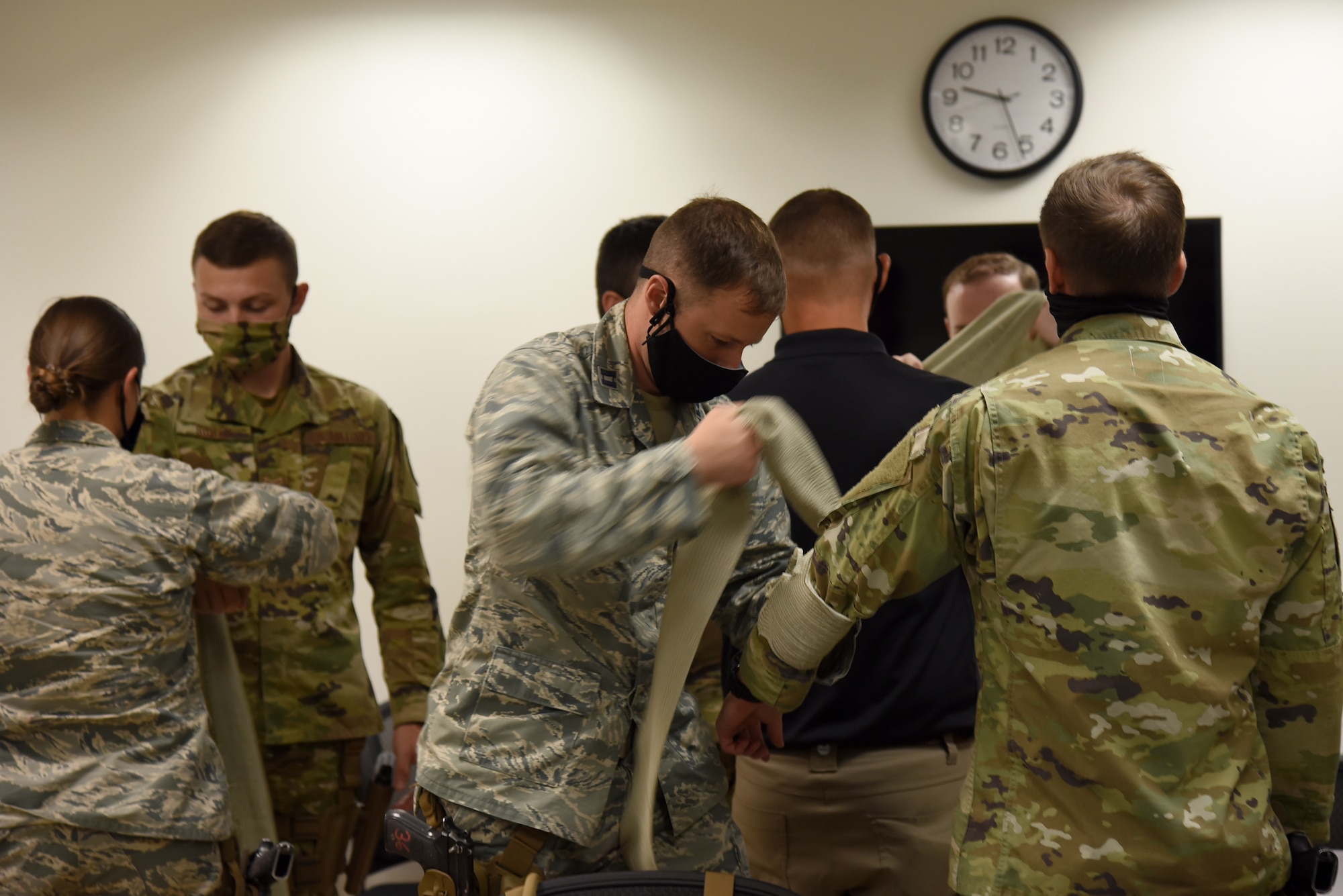 Photo of Airmen practicing applying pressure to a wound