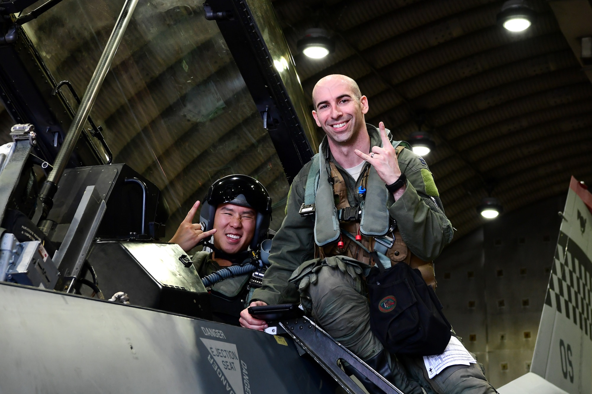 Maj. Chris Ng, 51st Medical Operations Squadron general surgeon, left, and Capt. Louis Bloom, 36th Fighter Squadron F-16 pilot, pose for a photo at Osan Air Base, Republic of Korea, July 28, 2020. Both hailing from Randolph, Massachusetts, the Randolph High School graduates continued their friendship while attending the United States Air Force Academy. Rekindling at Osan Air Base, their familiarization flight plans were initially derailed due to Bloom’s motorcycle accident. Ng’s medical expertise was instrumental to Bloom’s full and speedy recovery during the surgical and rehabilitation process, ultimately resulting in finally flying together. (U.S. Air Force photo by Senior Airman Noah Sudolcan)